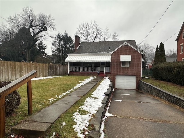 view of front of property with a garage and a front lawn