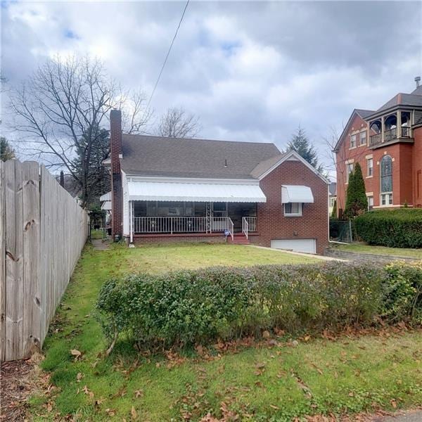 view of front of home with a garage and a front lawn