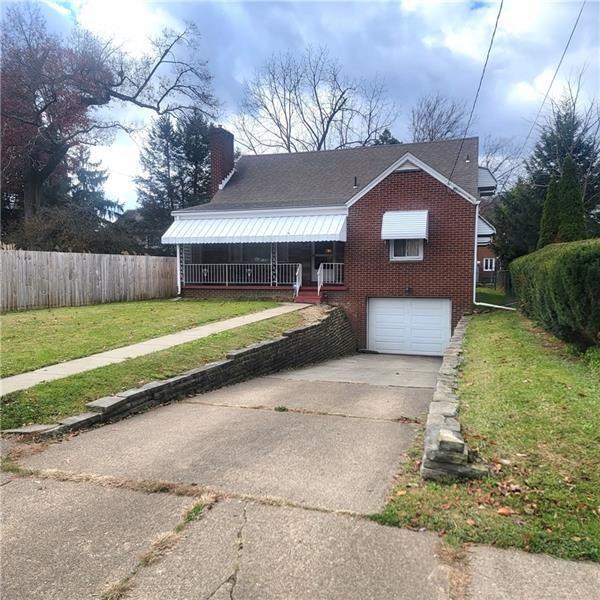 exterior space featuring a garage and a front lawn