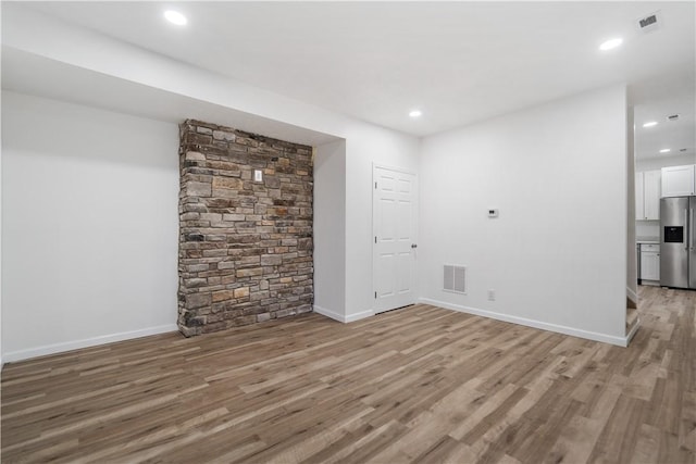 unfurnished room with light hardwood / wood-style flooring