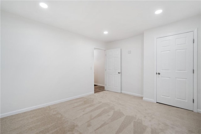 unfurnished bedroom featuring light colored carpet