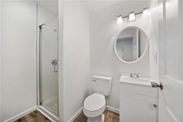 bathroom with wood-type flooring, toilet, a shower with door, and vanity