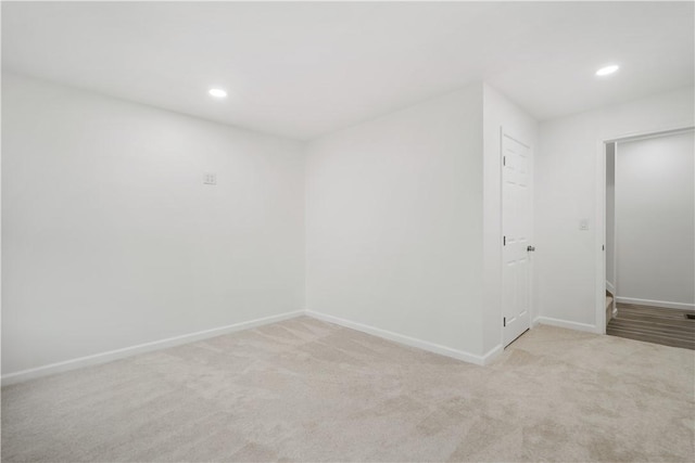 unfurnished room featuring light carpet