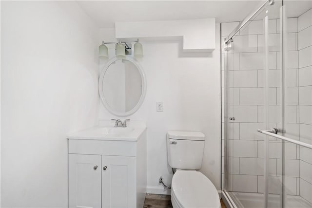 bathroom with vanity, toilet, and an enclosed shower