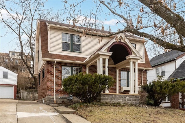 view of front of house with concrete driveway and brick siding