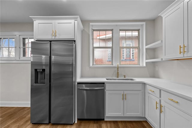 kitchen with white cabinetry, sink, plenty of natural light, and stainless steel appliances