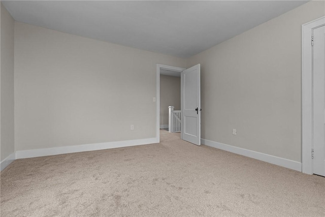 carpeted spare room with baseboards