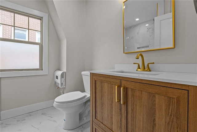 bathroom featuring vanity, toilet, baseboards, and marble finish floor