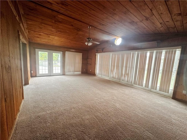 interior space with lofted ceiling, wooden ceiling, and ceiling fan