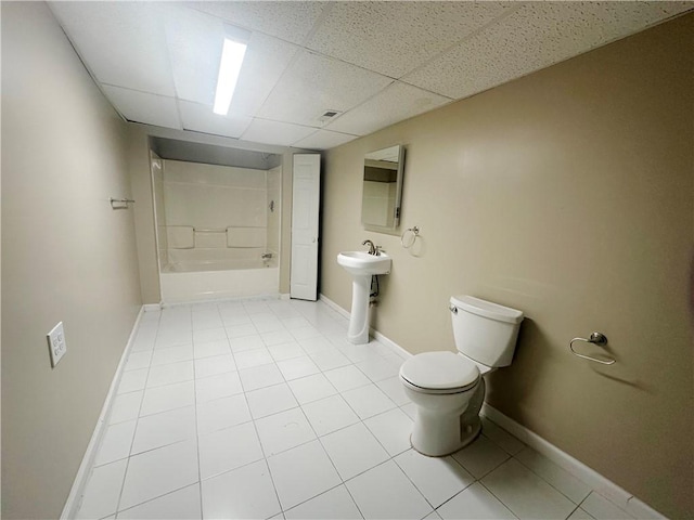 full bathroom featuring shower / washtub combination, a paneled ceiling, sink, tile patterned flooring, and toilet