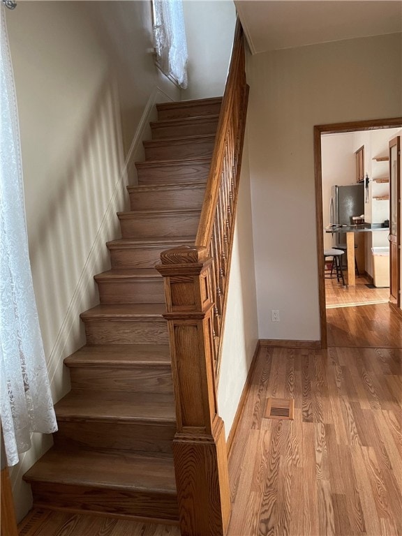 staircase with wood-type flooring