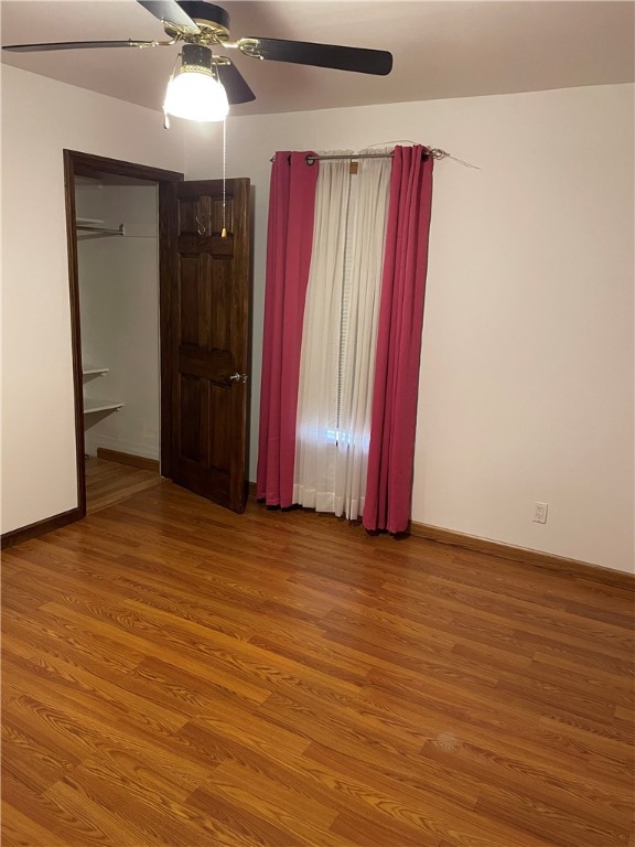 spare room featuring wood-type flooring and ceiling fan