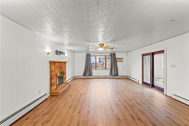 unfurnished living room with a baseboard heating unit, hardwood / wood-style flooring, a fireplace, and ceiling fan