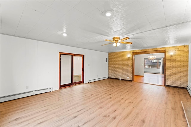 unfurnished living room featuring light hardwood / wood-style floors, brick wall, and baseboard heating