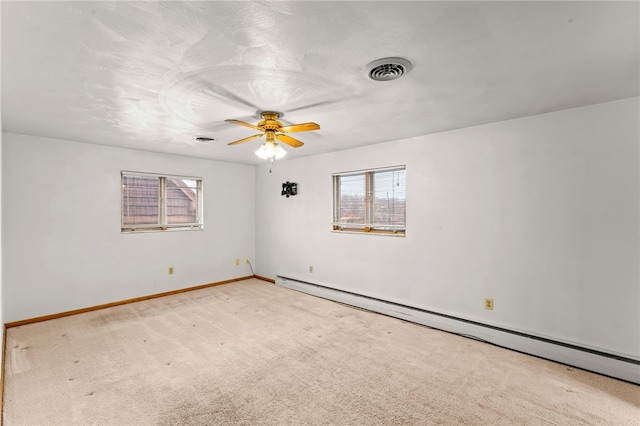 unfurnished room with a baseboard radiator, light colored carpet, and ceiling fan