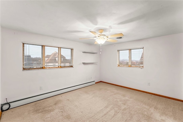 carpeted empty room featuring ceiling fan and baseboard heating