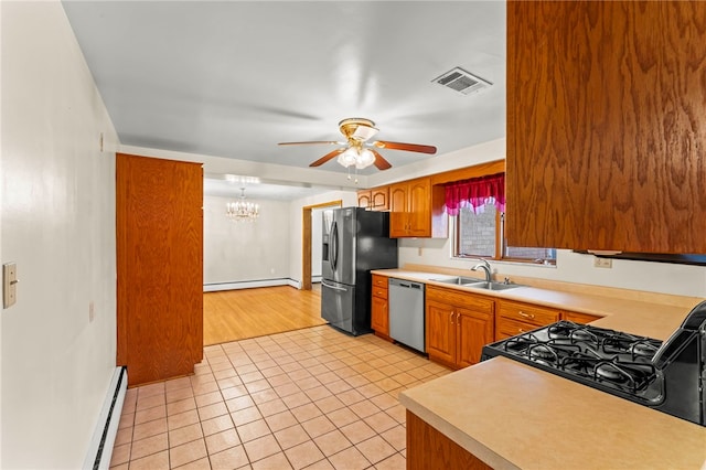 kitchen featuring light tile patterned floors, stainless steel appliances, sink, and a baseboard heating unit