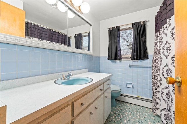 bathroom with tile patterned floors, toilet, tile walls, vanity, and a baseboard heating unit