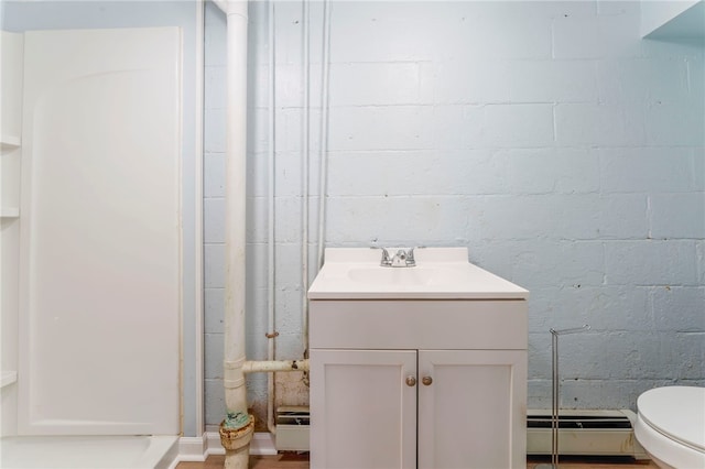 bathroom featuring vanity, toilet, and a baseboard heating unit