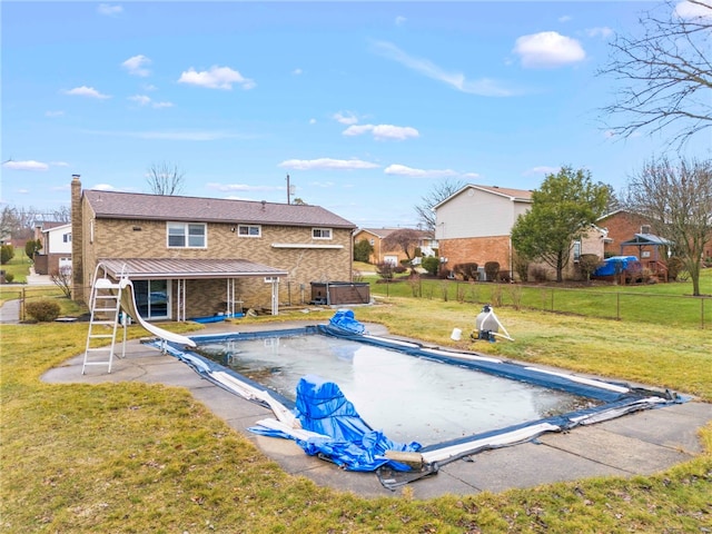 view of swimming pool with a lawn, a patio, and a water slide