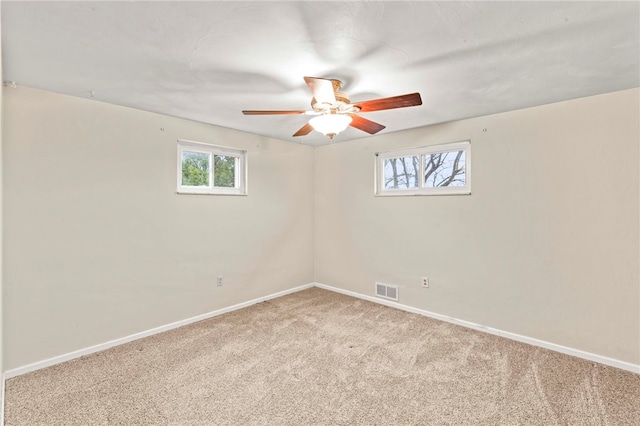 spare room featuring ceiling fan and light carpet