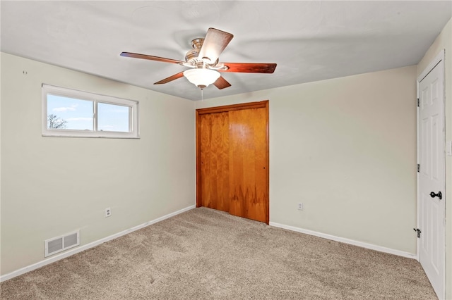 unfurnished bedroom with carpet floors, a closet, and ceiling fan