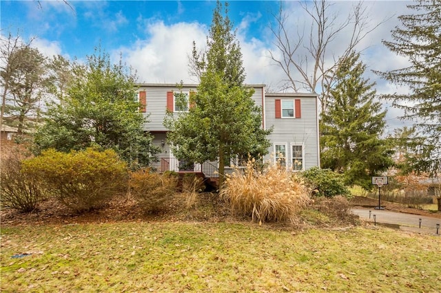 view of side of home featuring a lawn