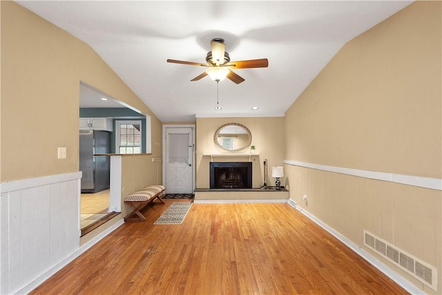 unfurnished living room featuring ceiling fan and light wood-type flooring