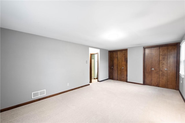 unfurnished bedroom with light colored carpet