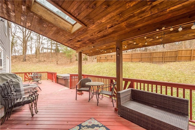 wooden deck with a yard and a jacuzzi