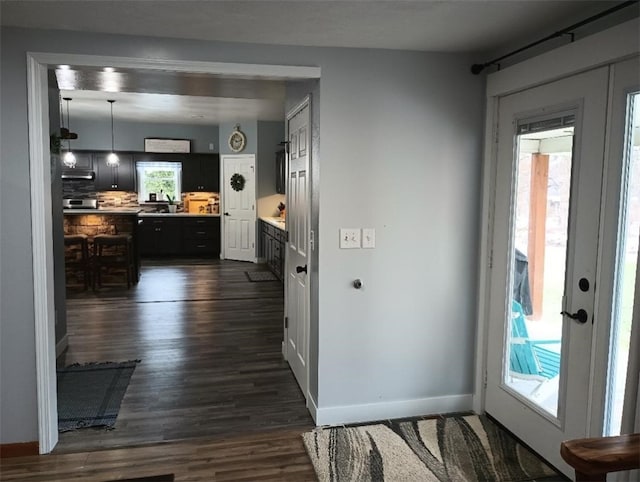 interior space featuring dark hardwood / wood-style floors and hanging light fixtures