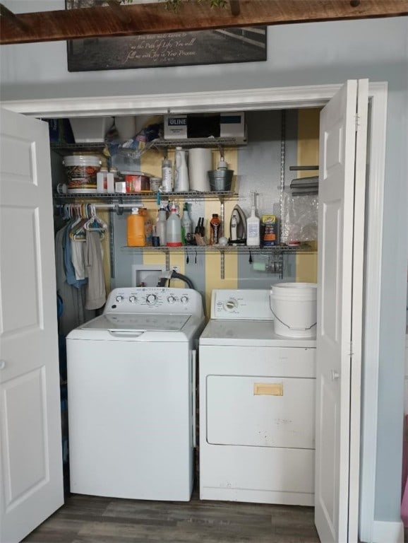 clothes washing area featuring separate washer and dryer and dark hardwood / wood-style floors