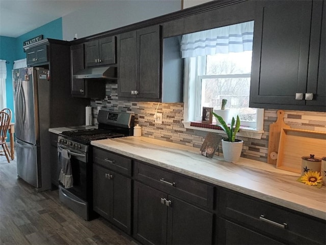 kitchen with stainless steel appliances, tasteful backsplash, and dark hardwood / wood-style flooring