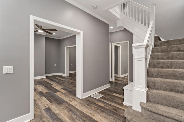 stairs featuring ornamental molding, hardwood / wood-style floors, and ceiling fan