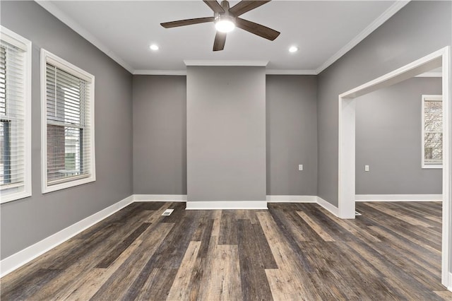 spare room featuring crown molding, a healthy amount of sunlight, and dark wood-type flooring