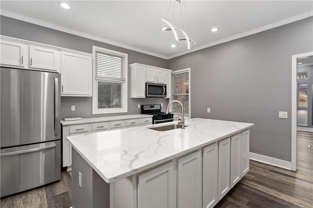 kitchen featuring white cabinetry, appliances with stainless steel finishes, an island with sink, and hanging light fixtures