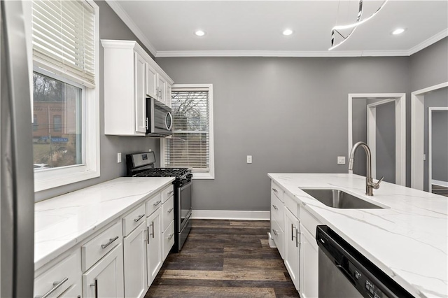 kitchen featuring white cabinetry, sink, ornamental molding, stainless steel appliances, and light stone countertops