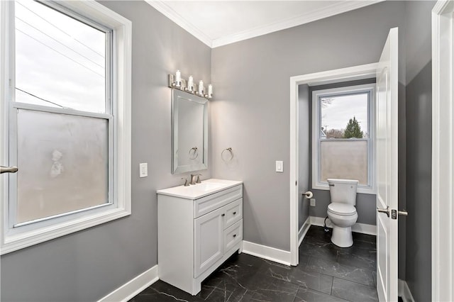 bathroom featuring ornamental molding, vanity, and toilet