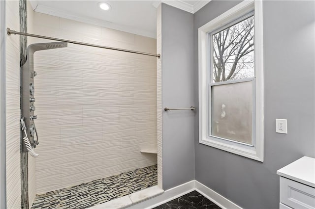 bathroom featuring vanity, crown molding, and tiled shower