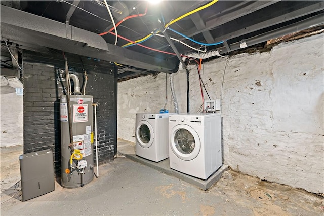 basement with washer and clothes dryer and water heater