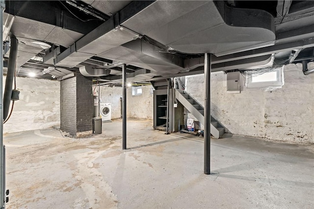 basement featuring washer / clothes dryer and electric panel