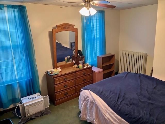 bedroom featuring radiator, carpet floors, and ceiling fan