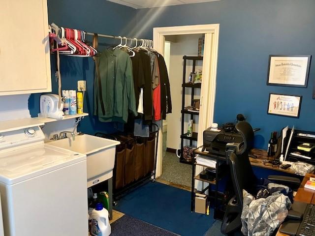 laundry room featuring washer / clothes dryer, dark colored carpet, and cabinets