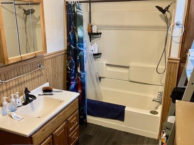 bathroom with shower / bathtub combination with curtain, vanity, hardwood / wood-style flooring, and wooden walls