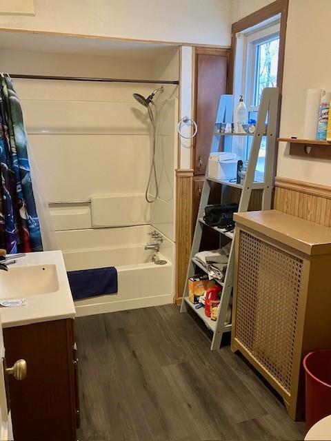 bathroom with wood-type flooring, shower / bath combo, and vanity