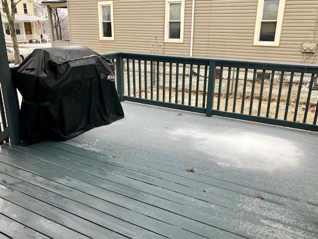 wooden deck featuring a grill