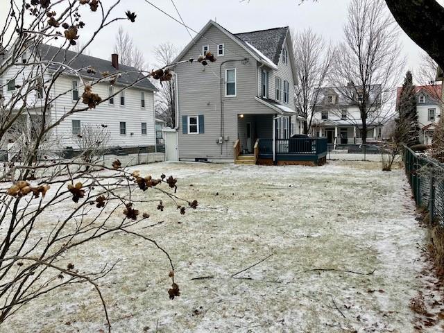 back of property featuring a wooden deck