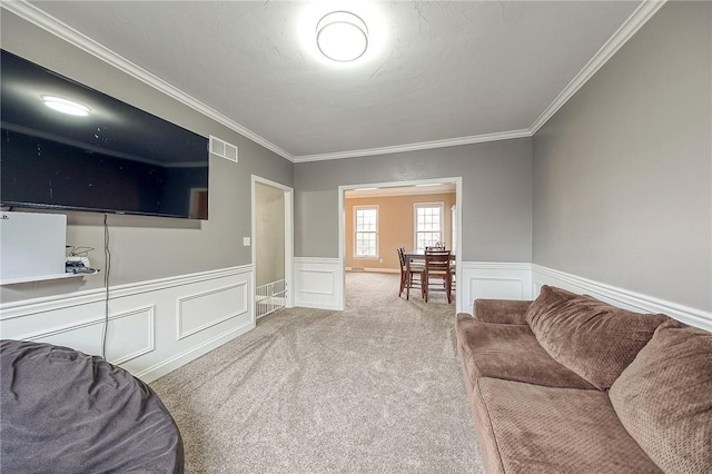 carpeted living room with ornamental molding