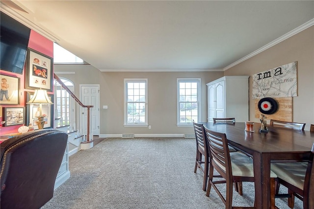 carpeted dining space featuring crown molding