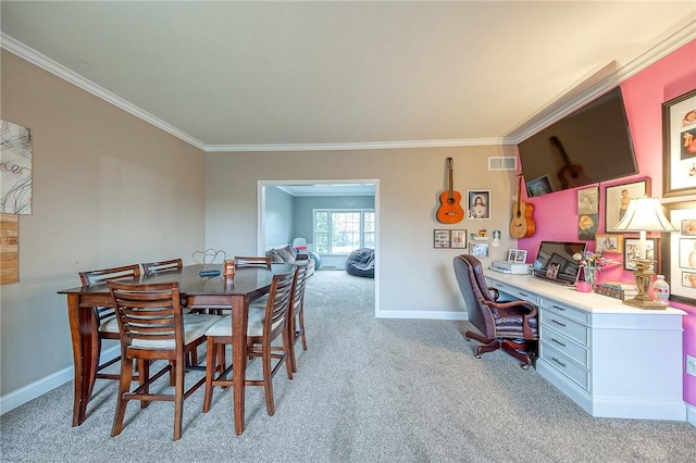 carpeted dining space with crown molding and built in desk